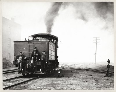 Three Men on the Back of a Switch Engine in an Unidentified Rail Yard by Unknown